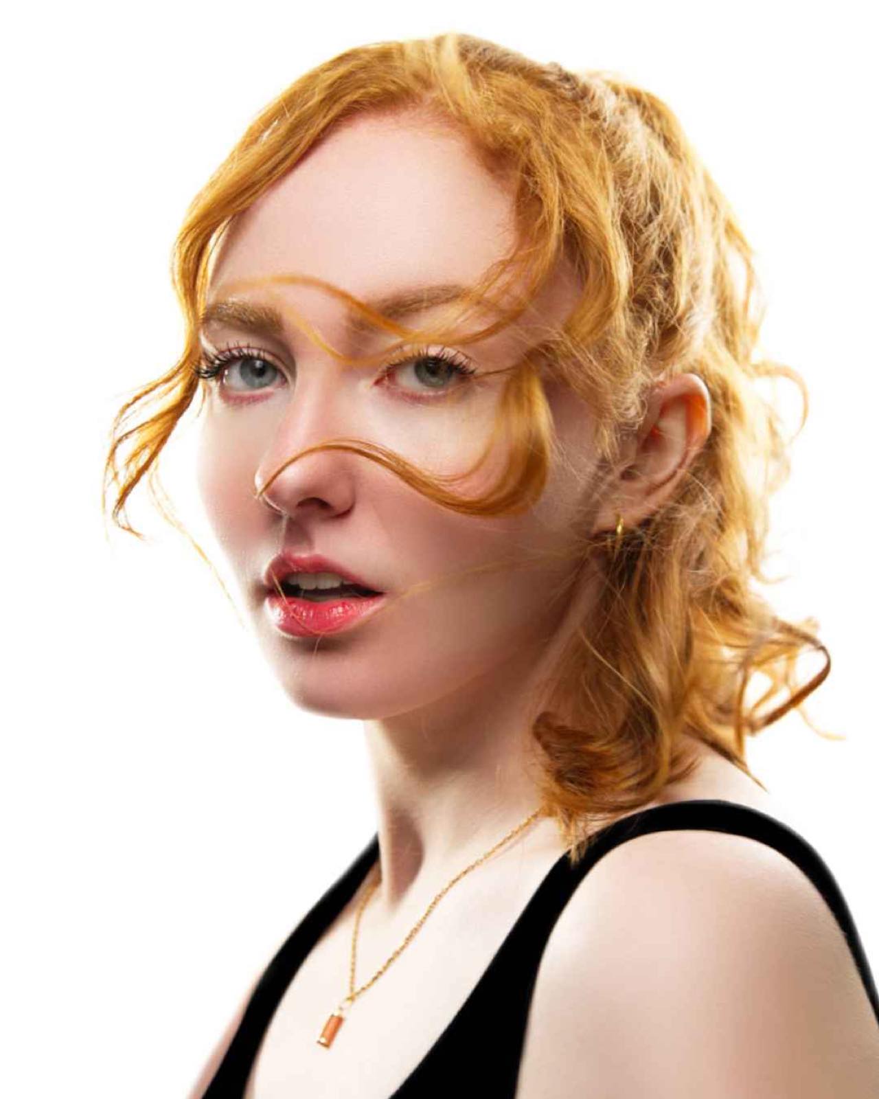 Portrait en lumière de studio d'une femme rousse sur fond blanc